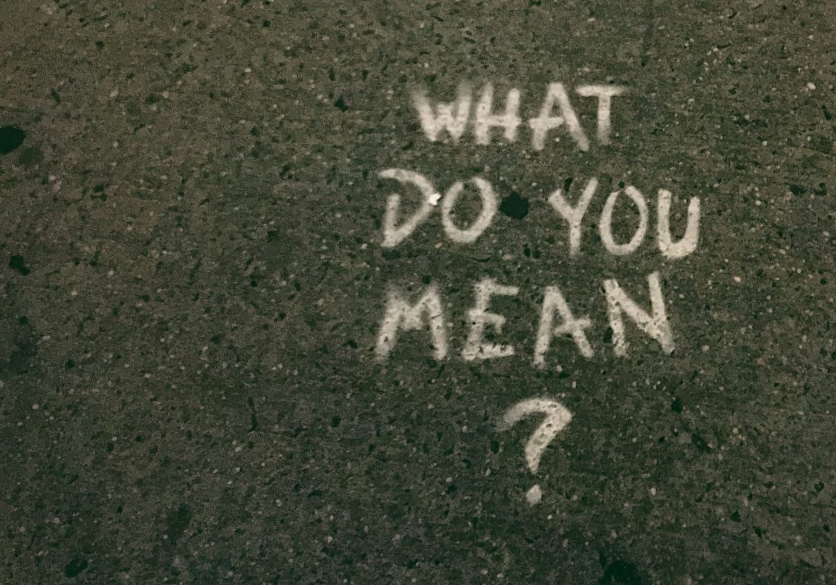 Spray painted graffitti of a quote: "What do you mean?"